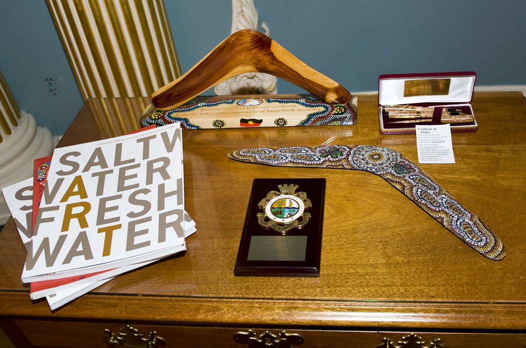 books pen boomerangs plaque